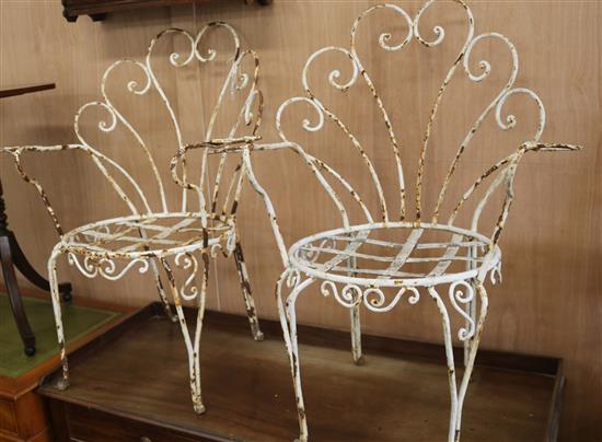 A pair of French wrought iron garden chairs